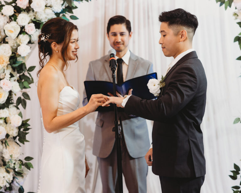 Bride and groom exchanging rings during their wedding ceremony
